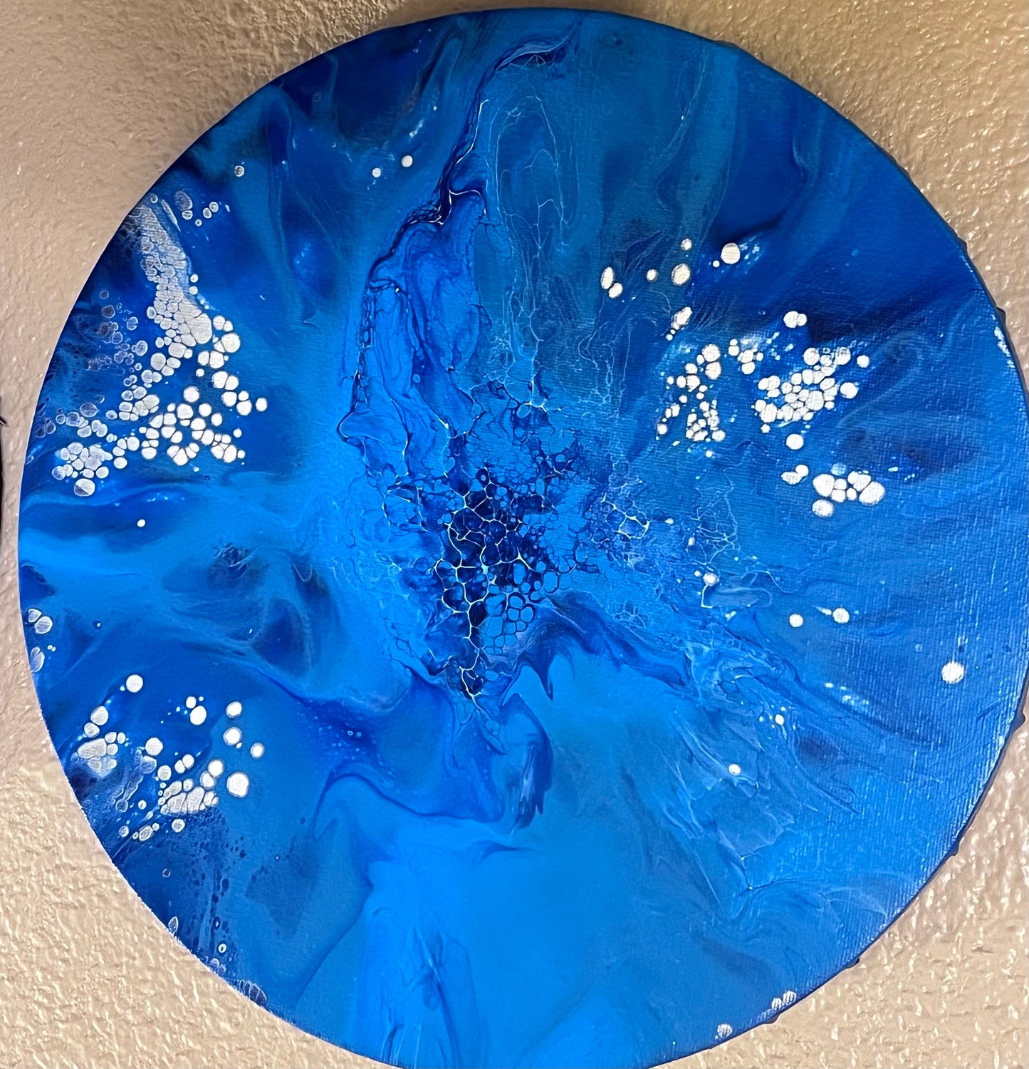 “Messiah” is a gorgeous 8x8 round, one of a kind, original abstract fluid artistry painting.